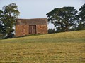 A stone hut in a field